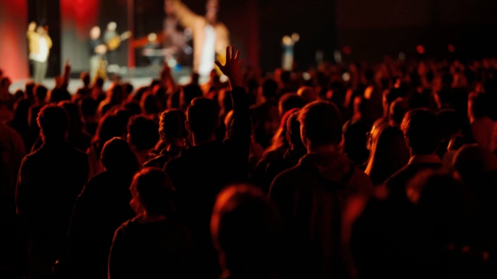 Concert crowd bathed in warm red light